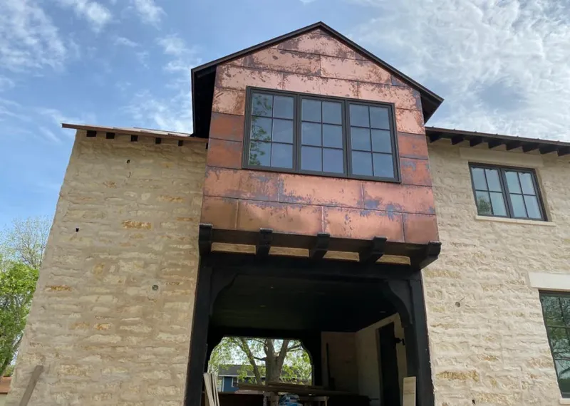 Copper metal panel facade on a stone building for Metal Roof Coating in Loveland